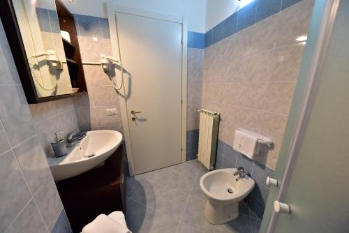 a bathroom with a sink and a toilet at Hotel La Pieve in Pieve Vergonte