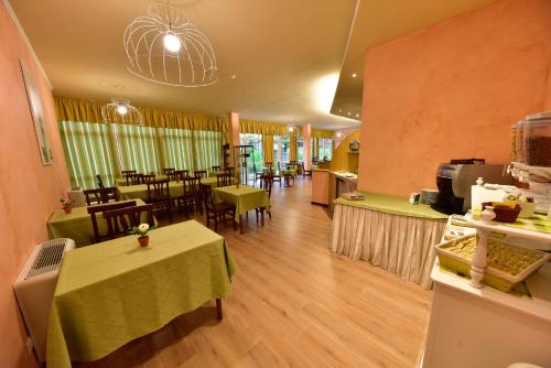 a restaurant with tables and chairs in a room at Hotel La Pieve in Pieve Vergonte