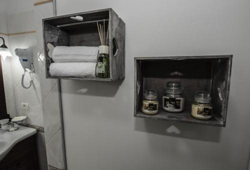 a bathroom with a towel dispenser on the wall at Villa Saturno in Tropea
