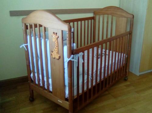 two wooden cribs sitting in a room with at Casa Rural Reparaz in Arbizu