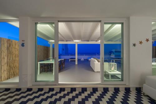 a living room with sliding glass doors at Casa del Faro in Torre Canne