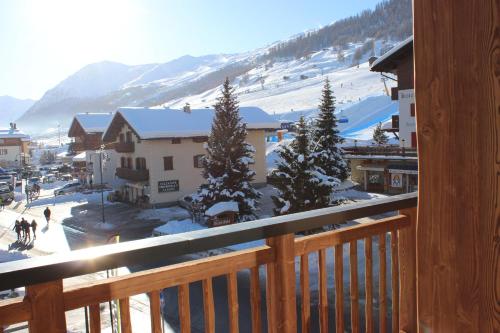 a view from a balcony of a town with snow at Chalet Teresa in Livigno