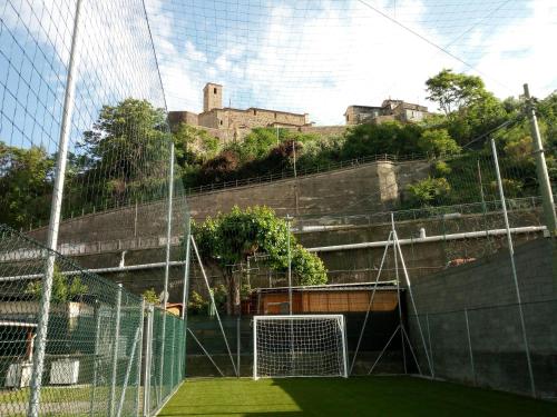a soccer field with a castle in the background at Camping Roma in Ventimiglia