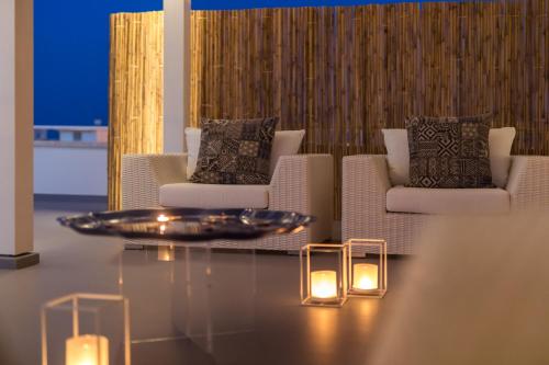 a living room with two chairs and a table with lights at Casa del Faro in Torre Canne