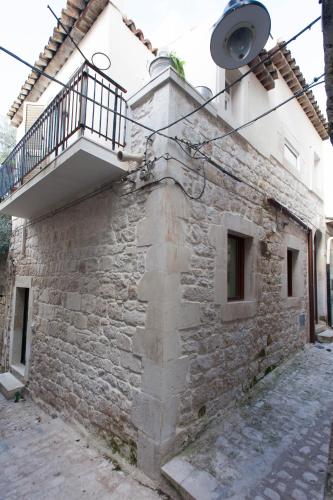 a building with a balcony on the side of it at Terrazzo Vinicio in Scicli