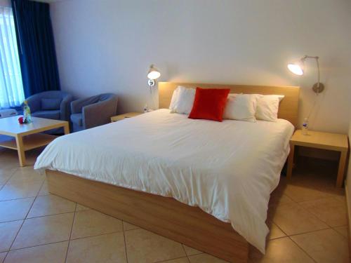 a bedroom with a large bed with a red pillow at Dolphin Key Resort - Cape Coral in Cape Coral