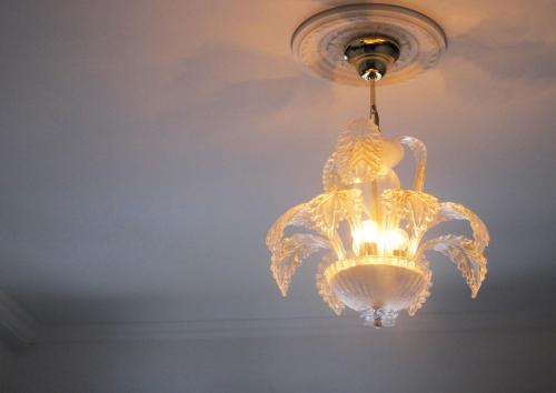 a glass chandelier hanging from a ceiling at Albergo Hotel Raffaello in Urbino