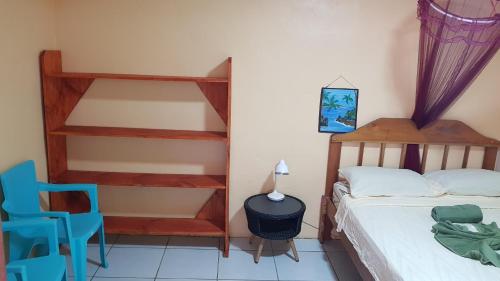 a bedroom with a bunk bed and a blue chair at Jacobin Hostel & Cabins in Drake