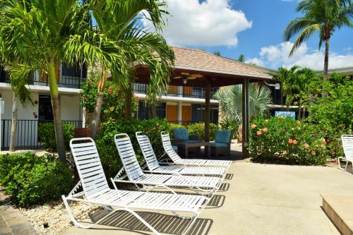 a row of white chairs sitting on a patio at Dolphin Key Resort - Cape Coral in Cape Coral