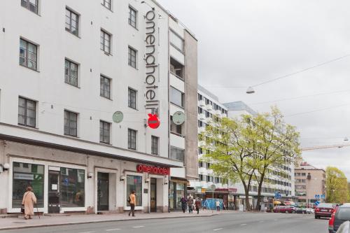 a white building with a sign on the side of it at Omena Hotel Turku Humalistonkatu in Turku