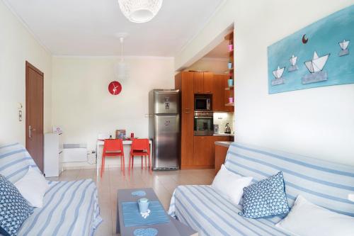 a living room with a couch and a kitchen at Sweet home with spectacular sea view in Paleo Tsifliki