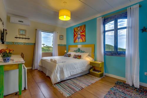 a bedroom with a bed and a large window at Villa do Arquiteto in Nova Petrópolis