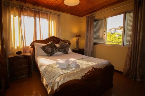 En eller flere senge i et værelse på Villa do Rosal