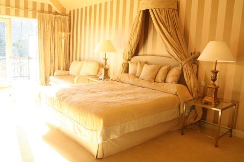 a bedroom with a large bed with a canopy at Restaurant Hotel Merlet in Schoorl