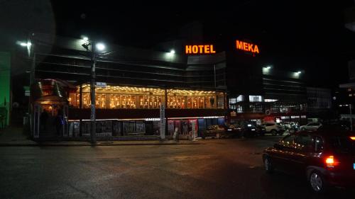 a hotel at night with a car parked in front of it at Meka Hotel in Dragash