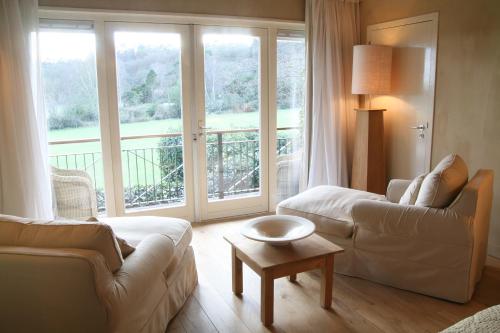 a living room with a couch and a table at Restaurant Hotel Merlet in Schoorl