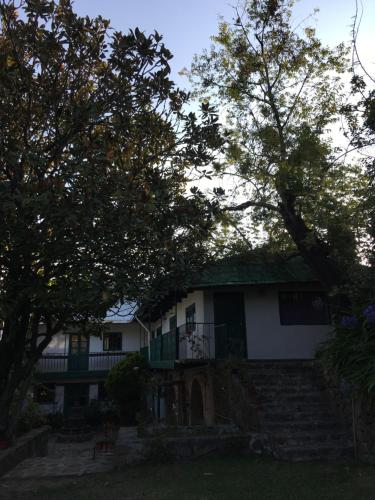 a white house with trees in front of it at Posada Santa María in Mineral del Chico