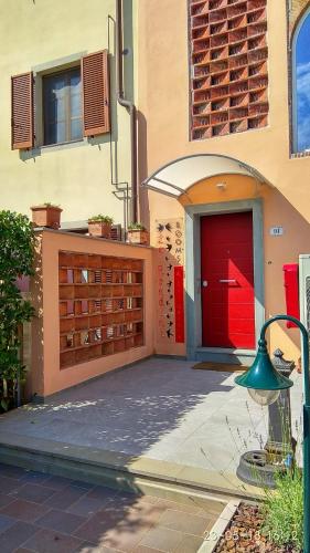 a red door on the side of a building at Le rondini di San Donato in Lucca