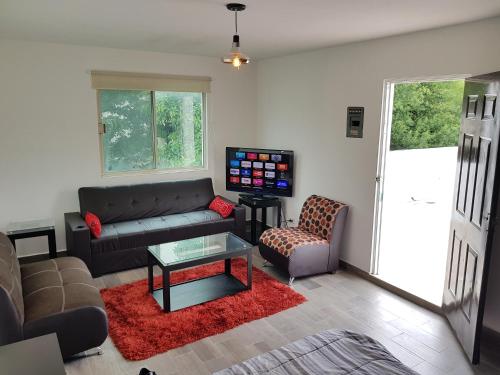 a living room with a couch and a table at Contry La Silla Apartments zona tec - Nuevo Sur in Monterrey