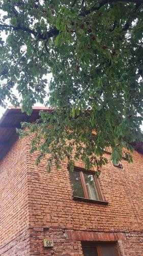 a brick building with a window on top of it at Bujaków, apartamenty Zdrojowa 58a in Bujaków