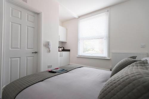 a bedroom with a bed and a window at Southsea Studios - Luxury Seaside Apartments in Portsmouth