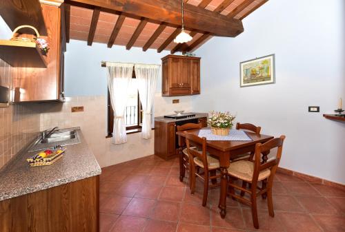 a kitchen with a table and chairs and a sink at Agriturismo La Pietraia in Poppi
