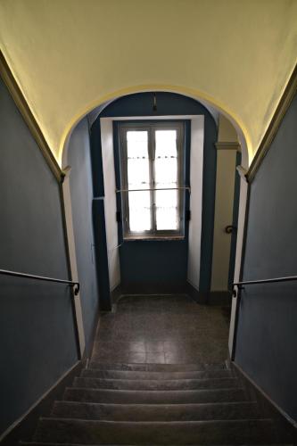 a hallway with stairs and a window in a building at Tuscany Experience BnB in Foiano della Chiana