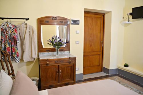 a bathroom with a dresser with a mirror and a sink at Tuscany Experience BnB in Foiano della Chiana