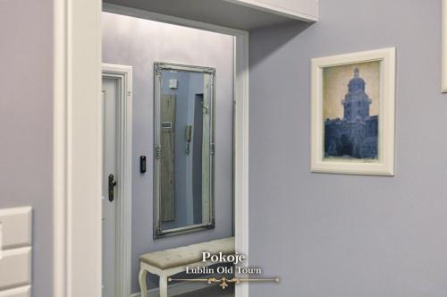 a mirror on a wall next to a door at Lublin Old Town Rooms in Lublin