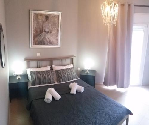 a bedroom with a bed with two stuffed animals on it at Grey House in Prinos