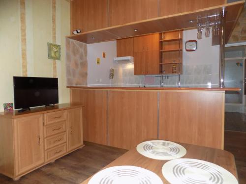 a kitchen with a table with two plates on it at Pokoje Goscinne MAXIM in Białogóra