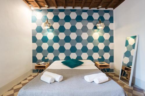 フィレンツェにあるF6 - Santa Croce one bedroom flat for 2 or 3 guestsのベッドルーム1室(青と白の壁のベッド1台付)