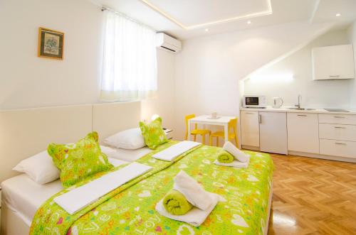 a bedroom with a bed and a kitchen in it at Apartman Split Old Town Center in Split