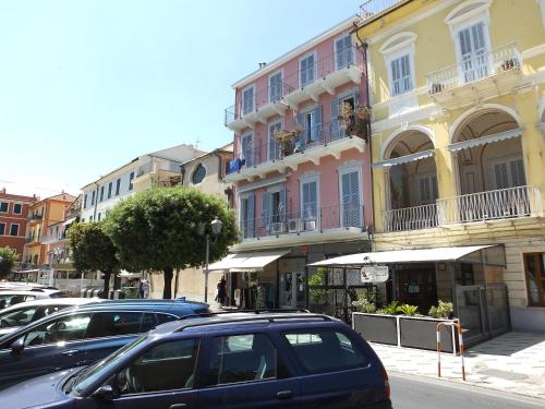 a group of cars parked in front of buildings at Casa Amico Mare in Loano