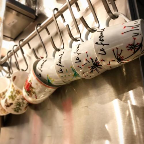 a bunch of cups are hanging on a rack at B&B Le Ferule in Manfredonia