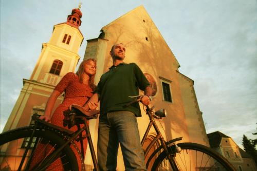 a man and a woman standing next to a bike at Ferienhaus Troadkasten - Familie Friedrich in Bad Waltersdorf