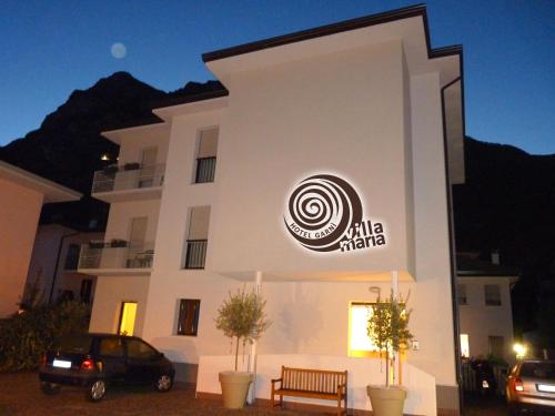 a building with a sign on the side of it at Hotel Garnì Villa Maria in Riva del Garda