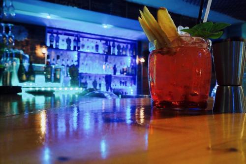 a drink sitting on a table in a bar at Paloma Blanca in Dassia