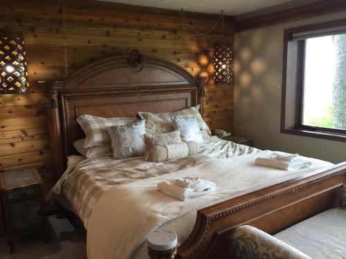 a bedroom with a large bed with two towels on it at Rudow Roost in Beech Mountain