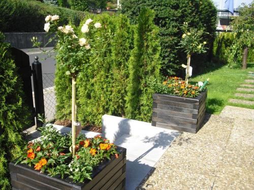 two wooden boxes with flowers in a garden at Gästehaus Cramer in Bad Kissingen