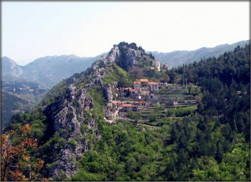 a village on the side of a mountain at Mini stone house in Omiš