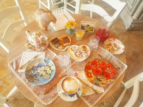a table topped with plates of food on a table at Agriturismo le Fontanelle da Valente in Montichiari