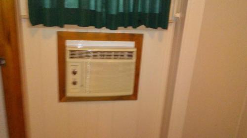 a door with a window with a fan on it at Catskill Motor Court in Catskill