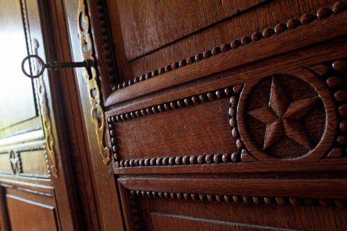 a wooden door with a design on it at Mas de la Chapelle in Arles