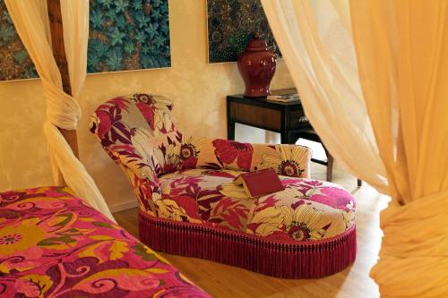 a chair with a book on it in a room at Mas de la Chapelle in Arles