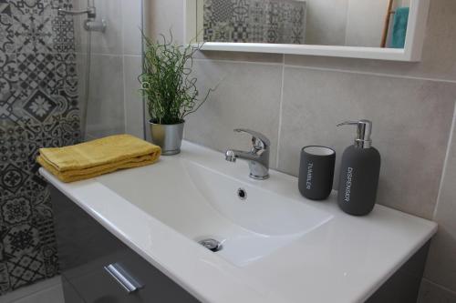 a bathroom sink with two toothbrushes on top of it at Casa da Azarujinha in Estoril