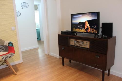 a television sitting on top of a dresser in a room at Casa da Azarujinha in Estoril