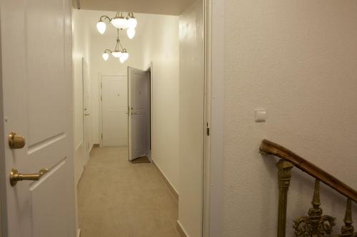 a hallway with a door and a stairway at Vilnius street apartment in Vilnius