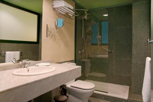 a bathroom with a sink and a toilet and a shower at Relaxia Lanzaplaya in Puerto del Carmen
