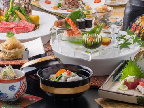 a table filled with dishes of food on plates at Yamagataya in Gero